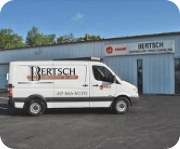 a work van with the Bertsch logo on the side parked in front of a warehouse
